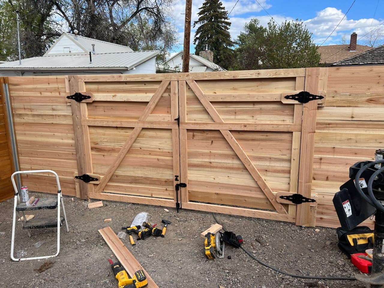 Cedar double drive gate with diagonal bracing built into a horizontal cedar fence, Elko, Nevada