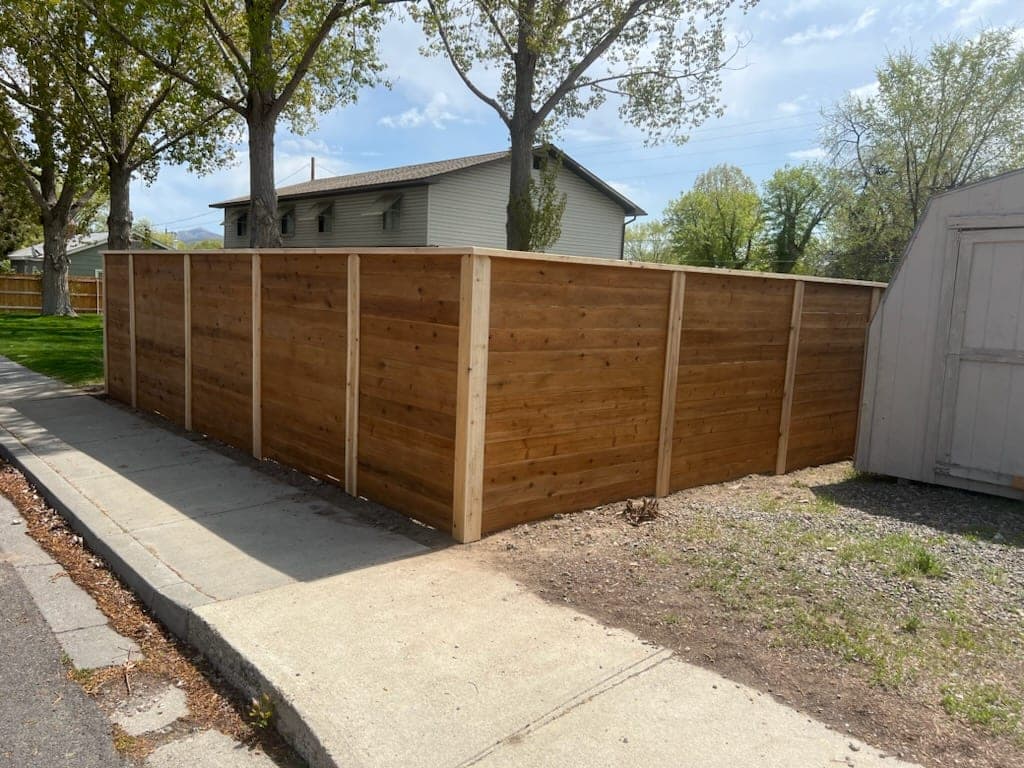 Corner of a horizontal cedar fence along a sidewalk in Elko, Nevada